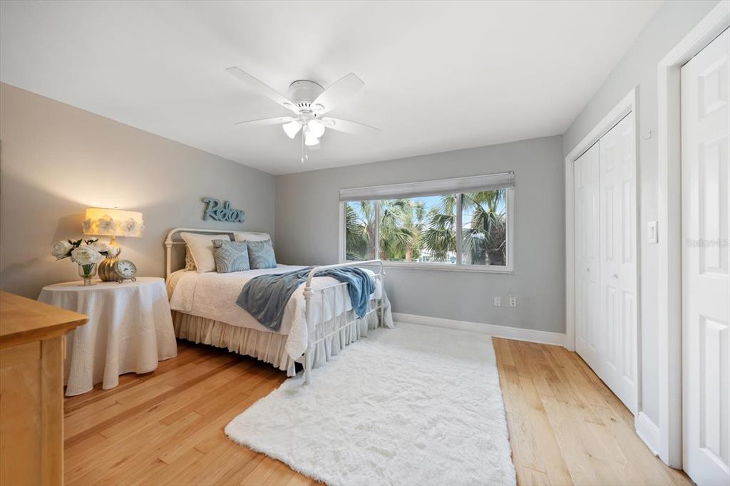 2515 Bay Boulevard, Unit B Indian Rocks Beach, FL 33785 - Photo 26 of 66 a bedroom with a large bed and a chandelier