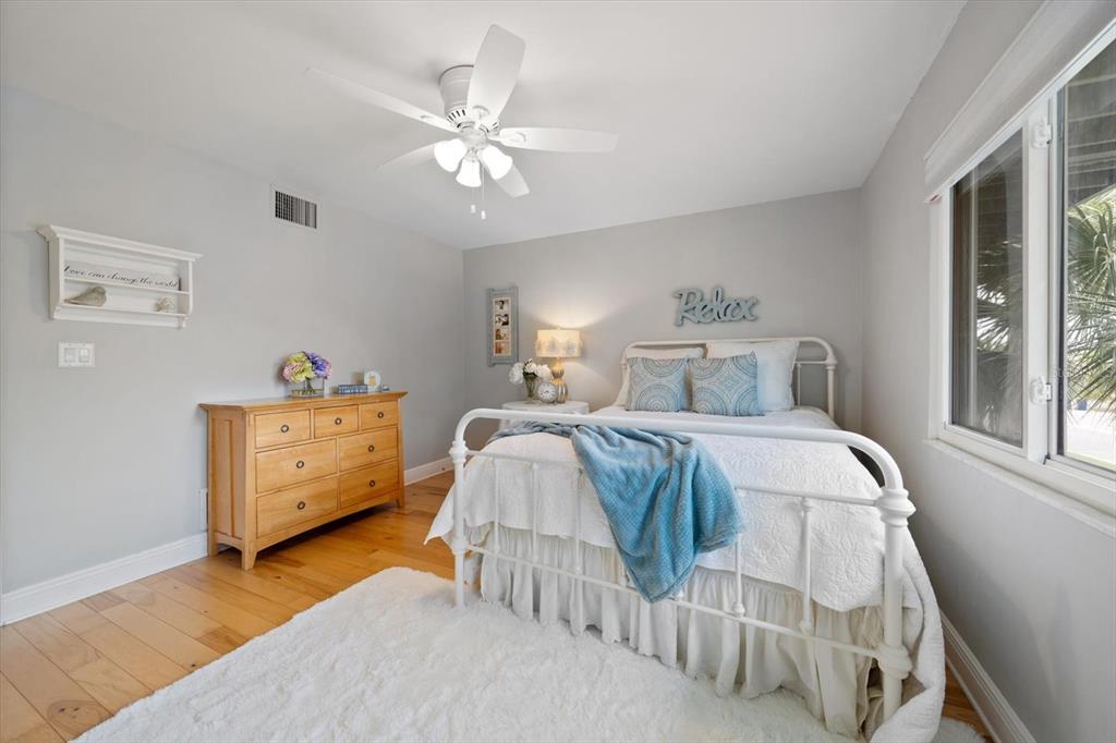 2515 Bay Boulevard, Unit B Indian Rocks Beach, FL 33785 - Photo 27 of 66 a bedroom with a bed and a chandelier