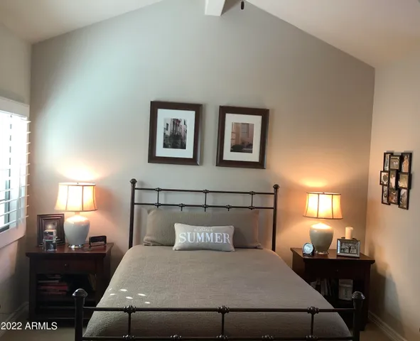 a bedroom with a bed lamps and window