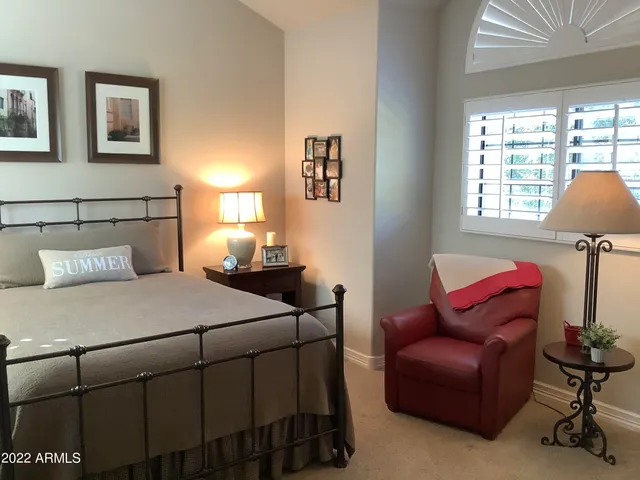 a bedroom with bed and window