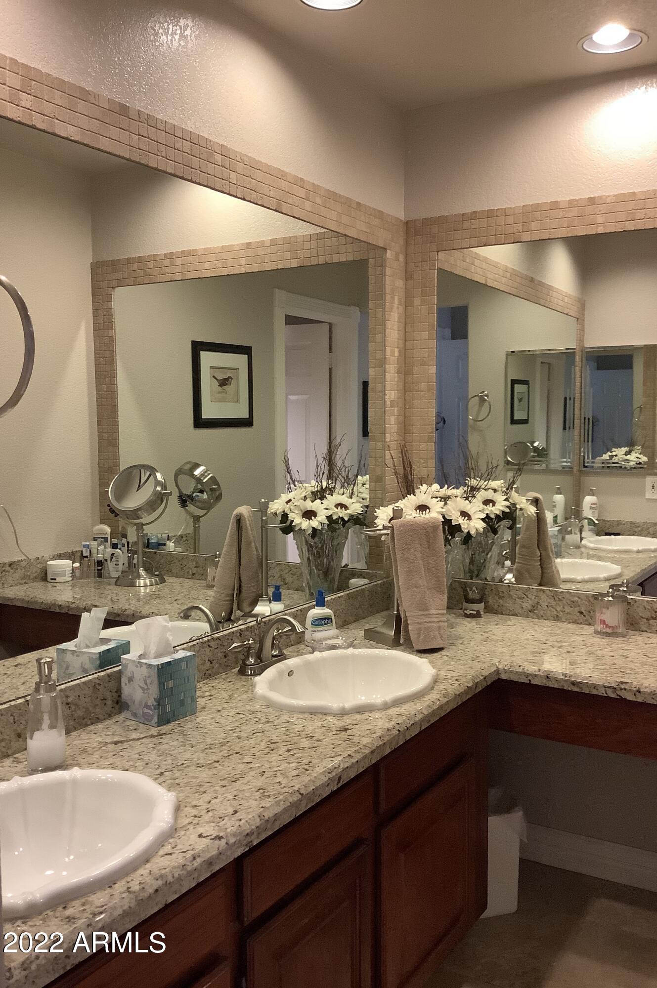7729 East Joshua Tree Lane Scottsdale, AZ 85250 - Photo 18 of 31 a bathroom with double vanity sinks and a mirror