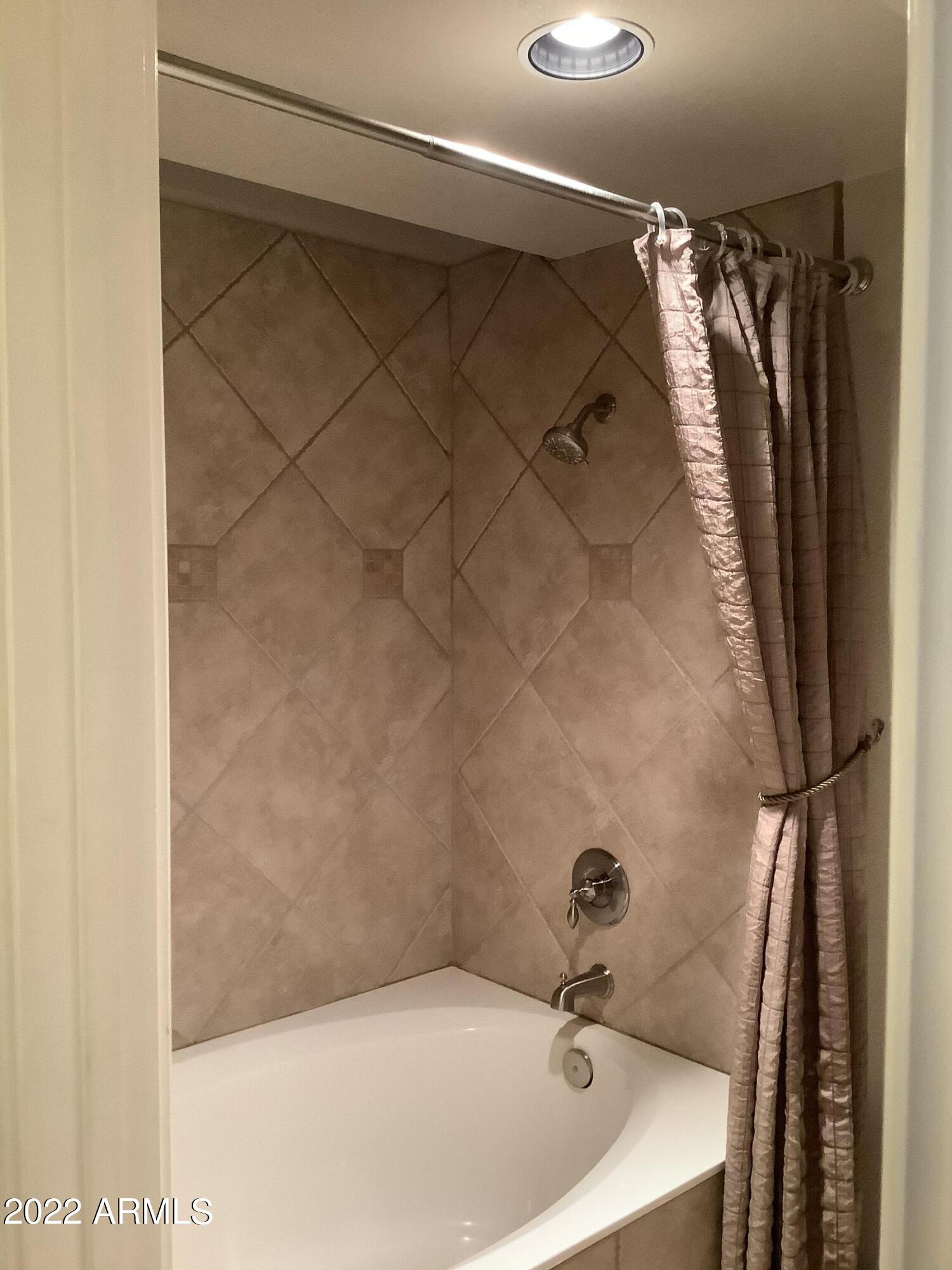 7729 East Joshua Tree Lane Scottsdale, AZ 85250 - Photo 19 of 31 a bathroom with a sink and shower