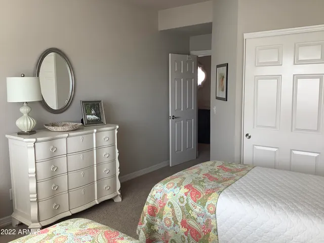 a bedroom with a bed and a dresser