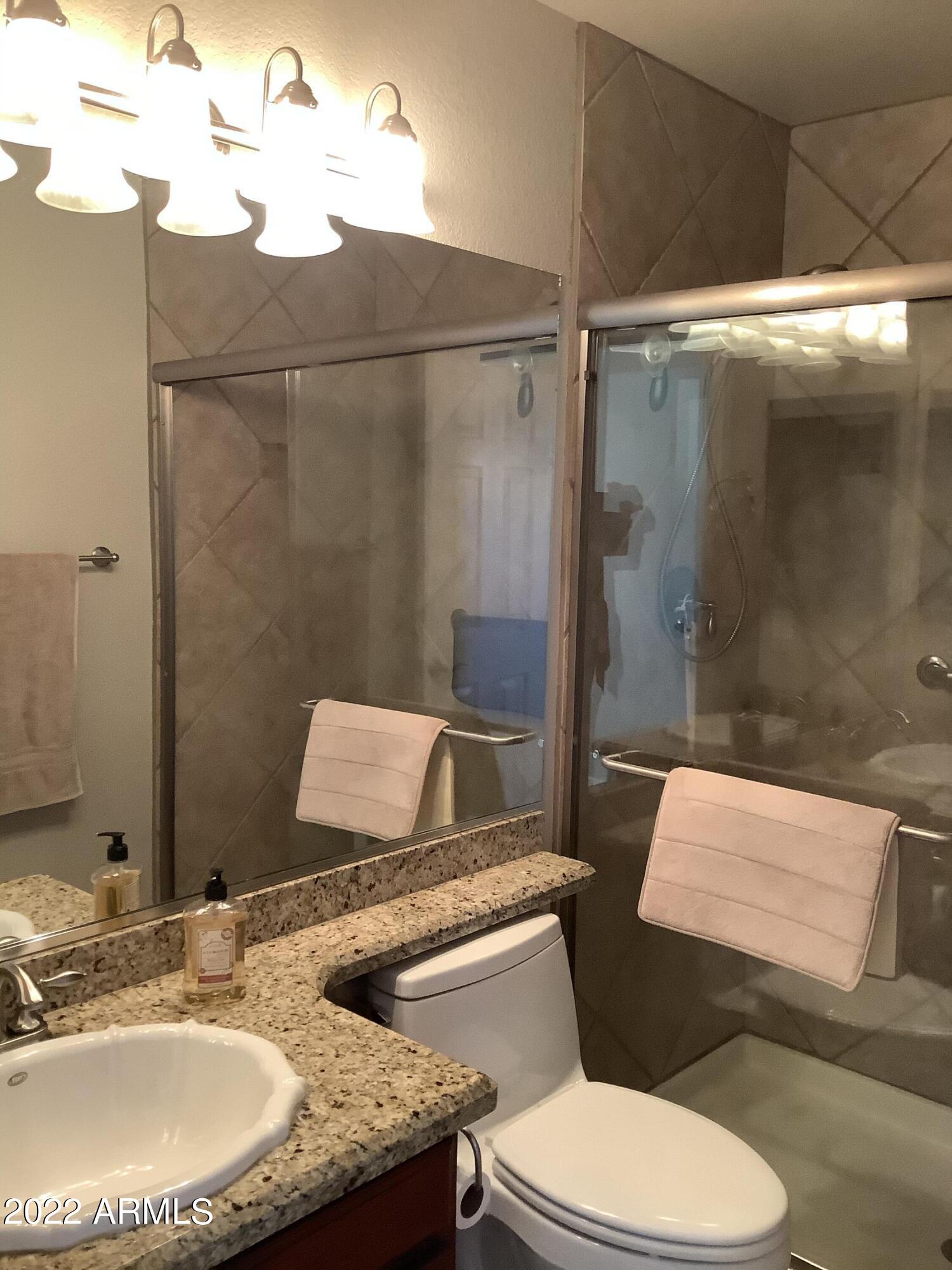 7729 East Joshua Tree Lane Scottsdale, AZ 85250 - Photo 22 of 31 a bathroom with a sink toilet and shower
