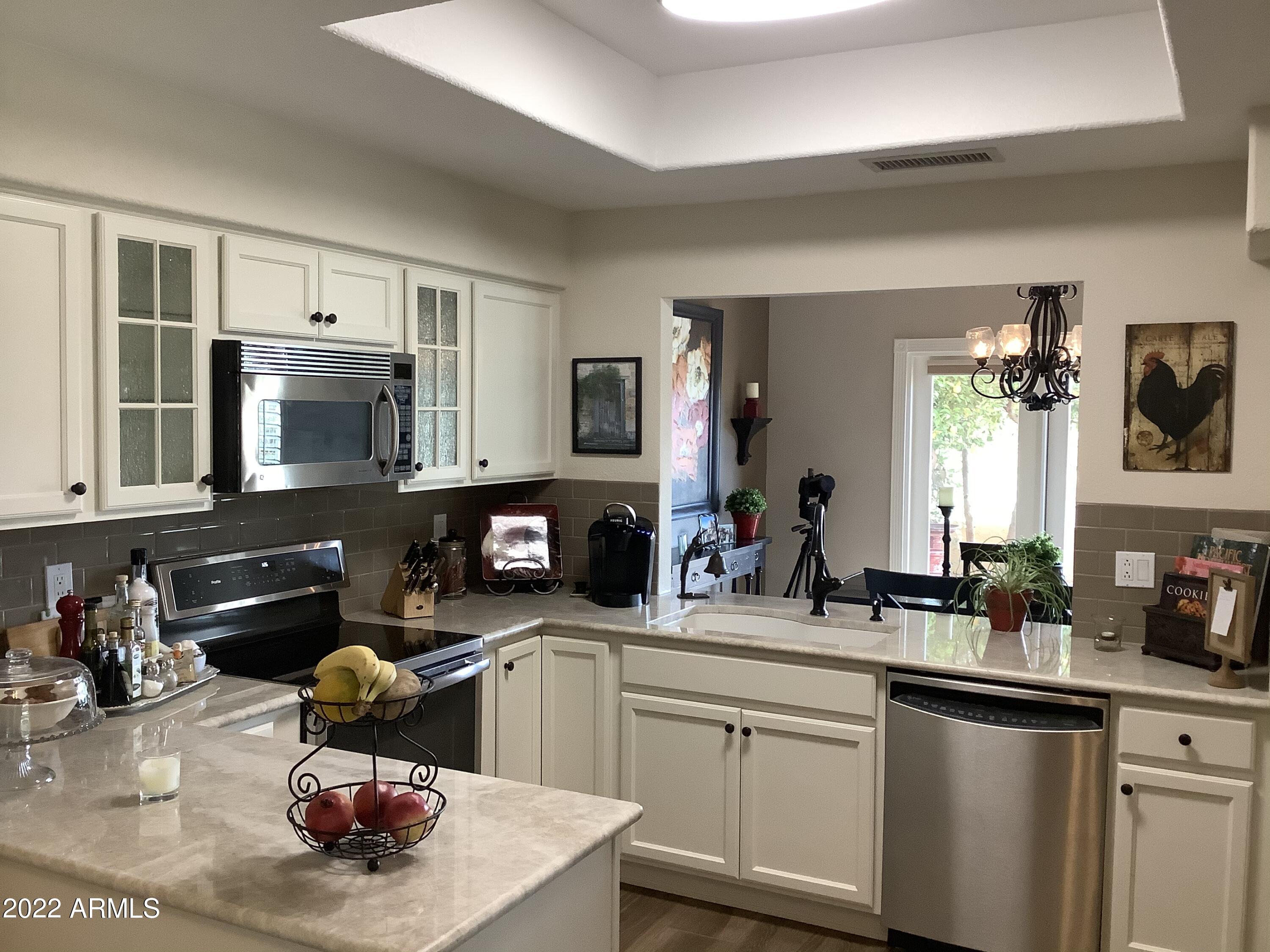 7729 East Joshua Tree Lane Scottsdale, AZ 85250 - Photo 6 of 31 a kitchen with a sink stove and microwave