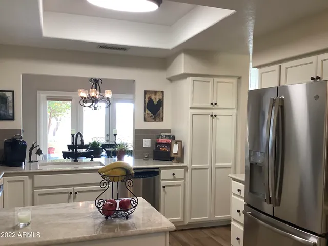 a kitchen with refrigerator and cabinets