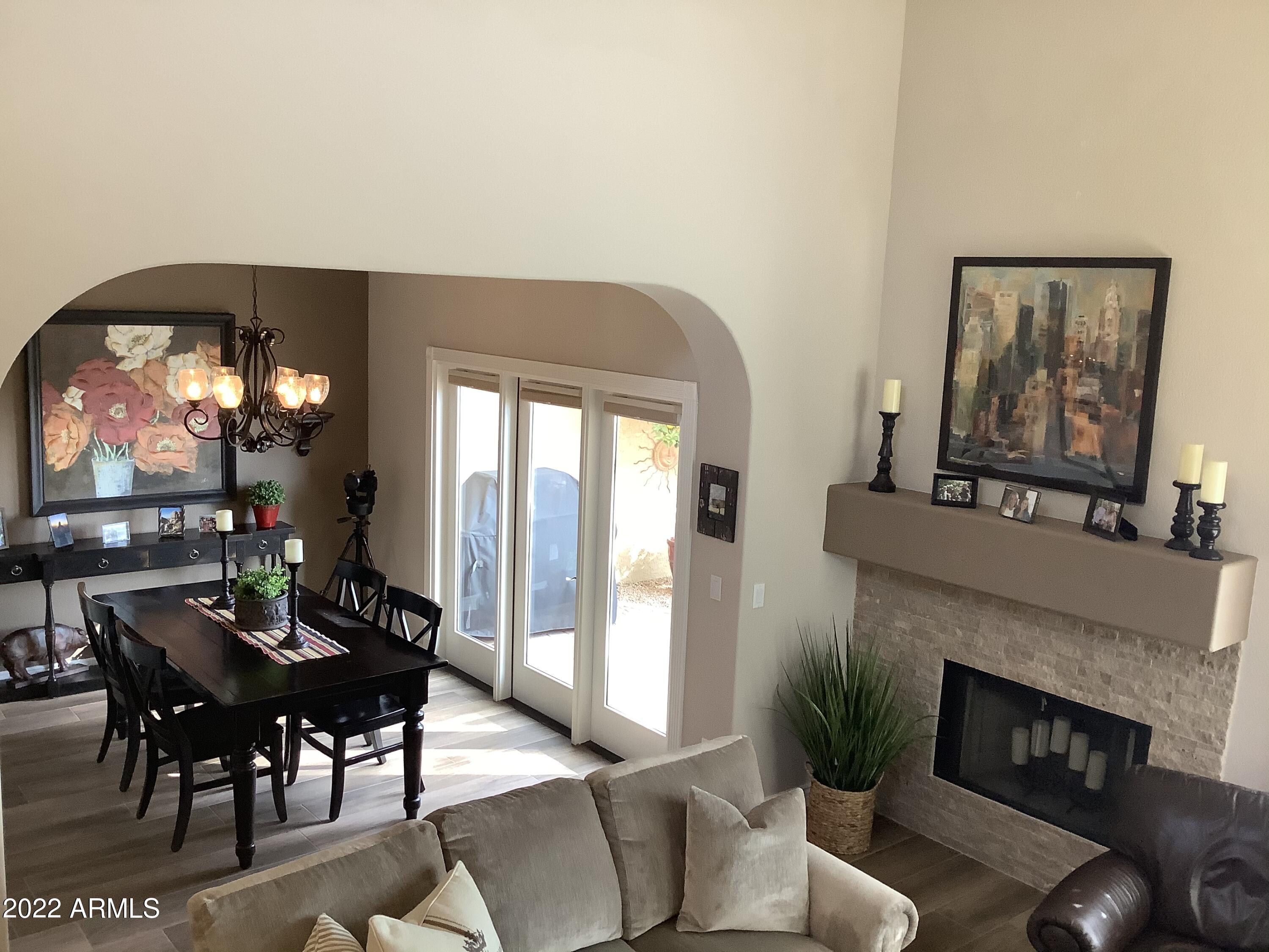 7729 East Joshua Tree Lane Scottsdale, AZ 85250 - Photo 10 of 31 a living room with furniture a window and a fireplace