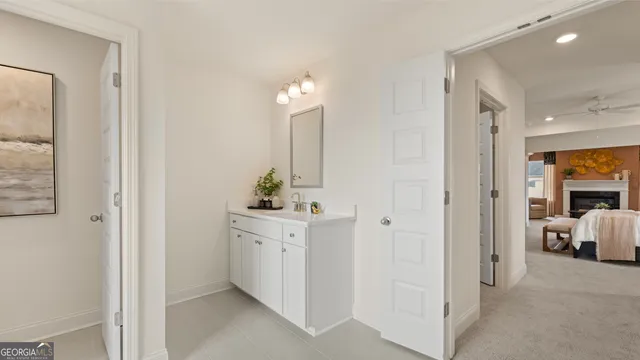 a kitchen with granite countertop white cabinets and black appliances