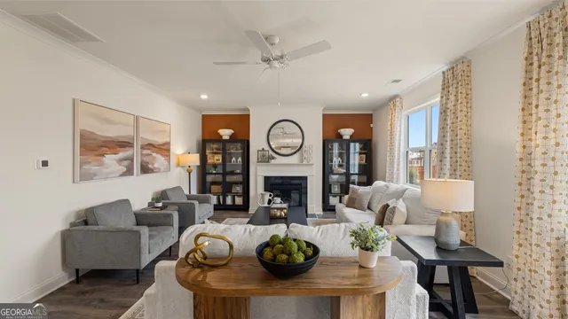 a living room with furniture and a wooden floor