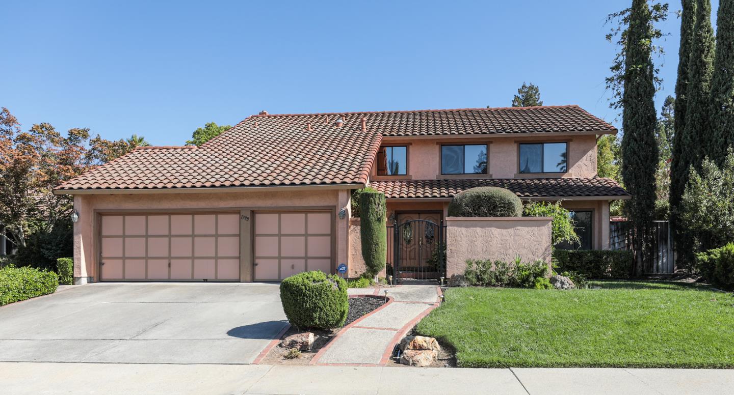 a front view of a house with a garden and plants