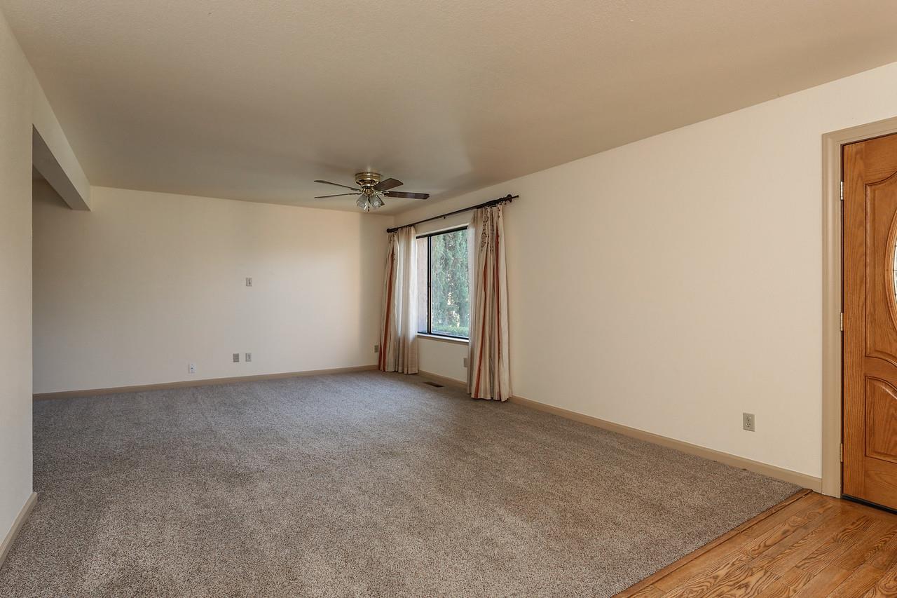 1398 Pierce Ranch Road San Jose, CA 95120 - Photo 3 of 32 an empty room with wooden floor and windows