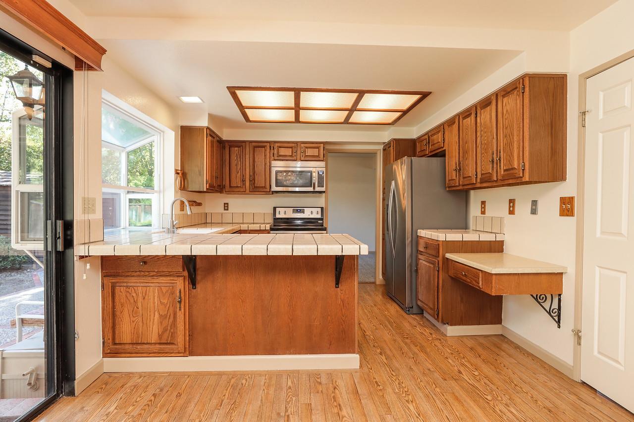 1398 Pierce Ranch Road San Jose, CA 95120 - Photo 7 of 32 a kitchen with stainless steel appliances granite countertop a stove a sink dishwasher and a refrigerator with wooden floor