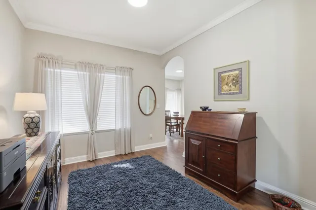 a living room with furniture and dresser