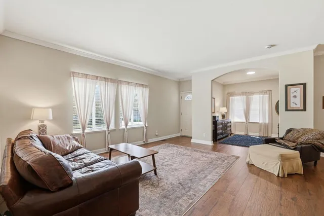 a kitchen with granite countertop a stove top oven a sink a counter space and cabinets