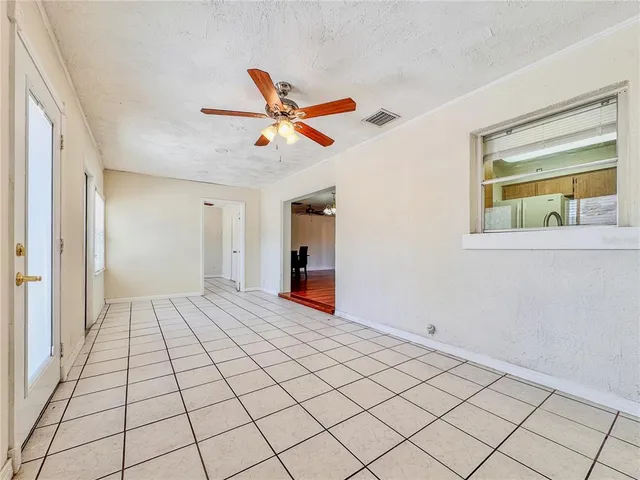 a view of a livingroom with wooden floor and a ceiling fan