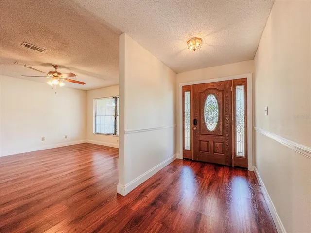 a view of a room with wooden floor