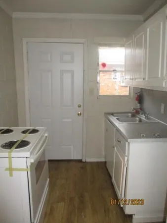 a kitchen with a sink a stove a refrigerator and cabinets