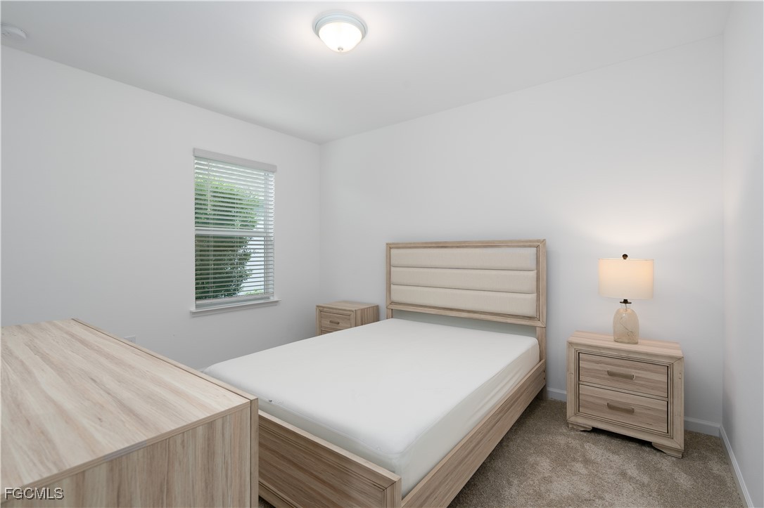 42428 Cascade Drive Punta Gorda, FL 33982 - Photo 12 of 49 a bedroom with a bed and a window