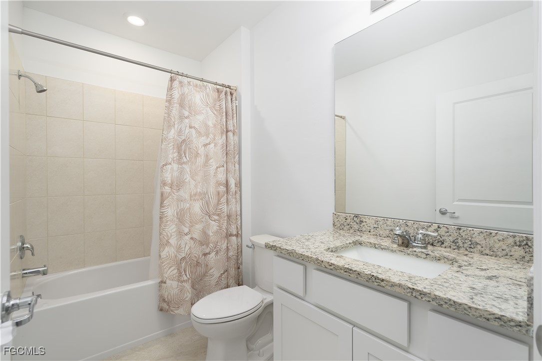42428 Cascade Drive Punta Gorda, FL 33982 - Photo 14 of 49 a bathroom with a granite countertop sink toilet and shower
