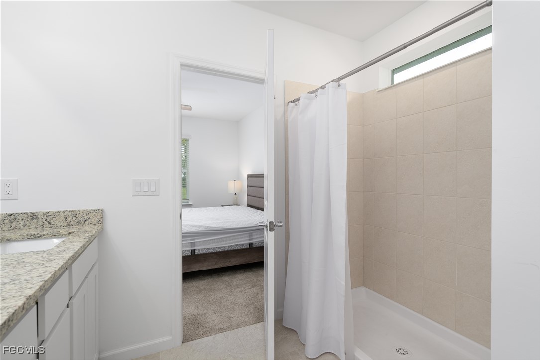 42428 Cascade Drive Punta Gorda, FL 33982 - Photo 16 of 49 a en suite bathroom with a granite countertop sink and a mirror