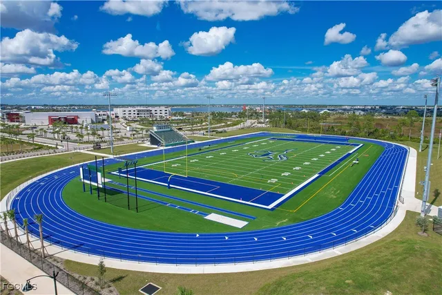 a view of a swimming pool with a patio and a yard