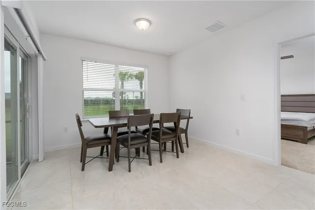 a view of a dining room with furniture and window