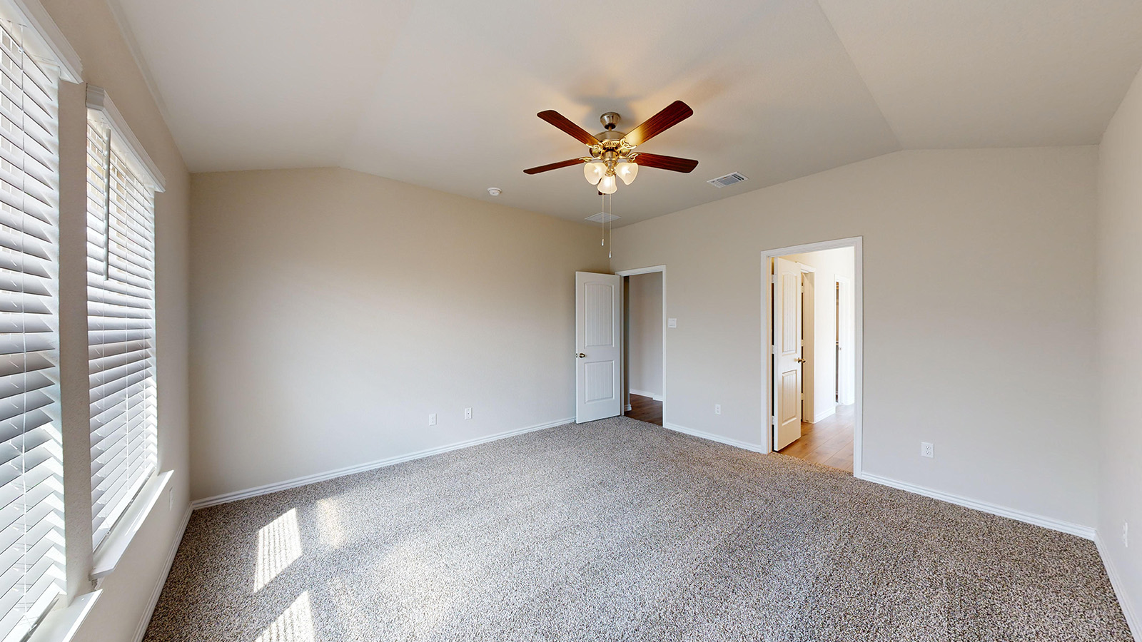243 Water Wl Road Burnet, TX 78611 - Photo 11 of 23 Spacious room featuring vaulted ceilings, neutral-toned walls, and plush carpeting