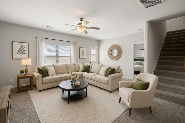 a living room with furniture a chandelier and a window