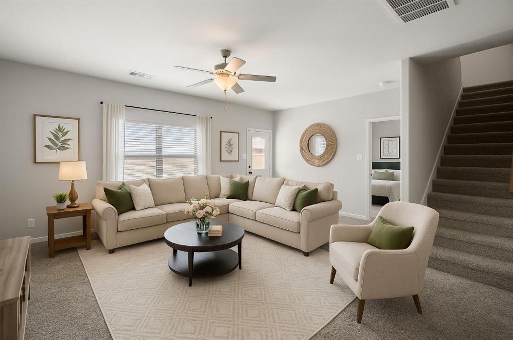 a living room with furniture a chandelier and a window