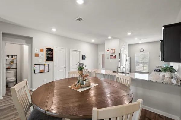a living room with dining room and wooden floor