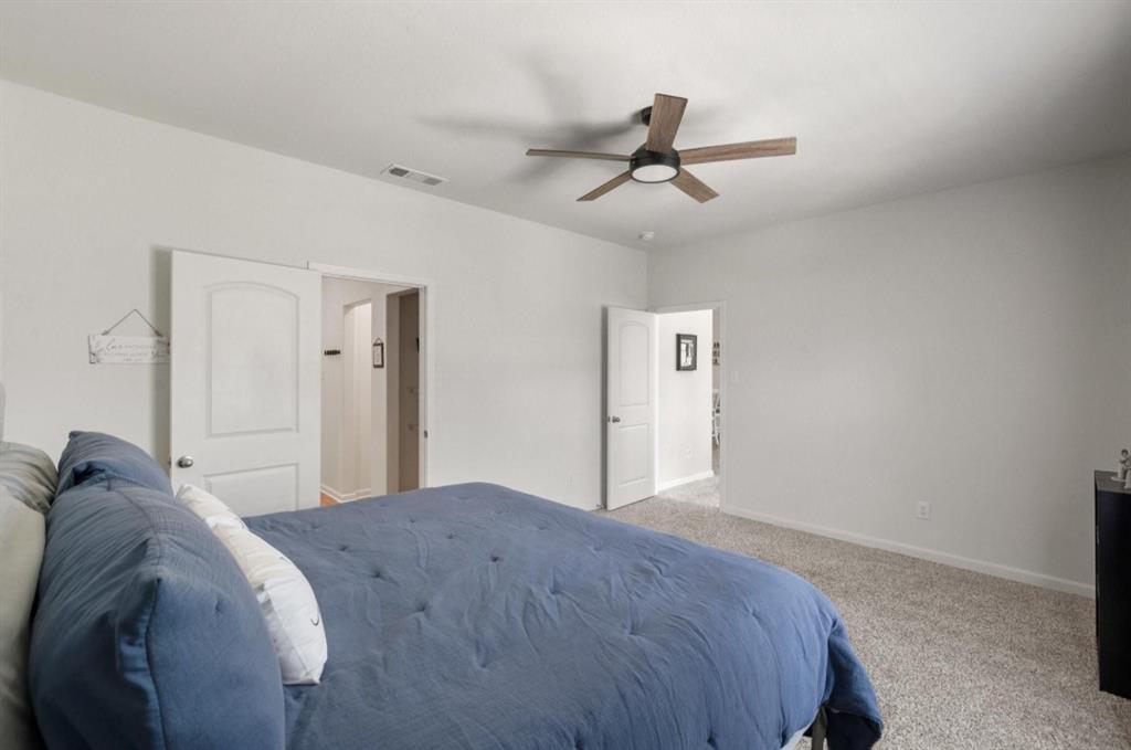 159 Sammy Fowler Avenue Venus, TX 76084 - Photo 17 of 36 a bedroom with a bed and a ceiling fan