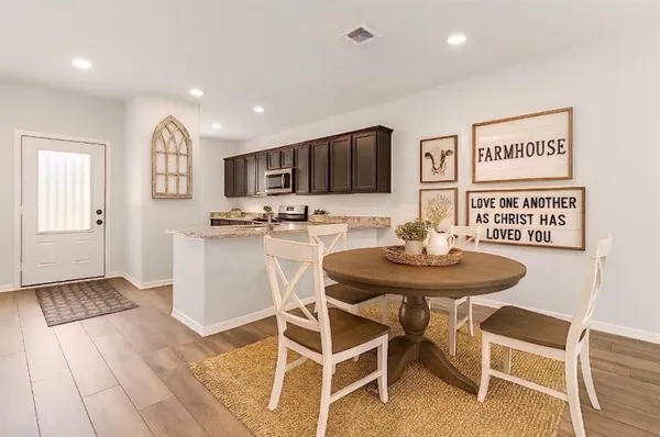 a view of a dining room with furniture and wooden floor