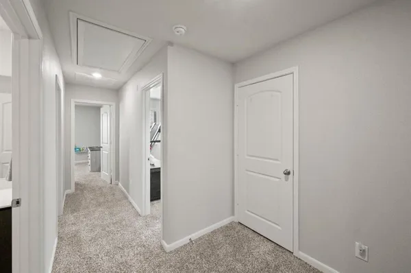 a view of a hallway with wooden shelves