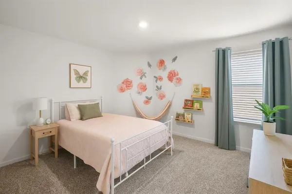 a bedroom with a bed and a couch