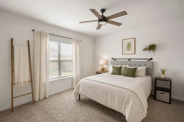 a bedroom with a large bed and a window