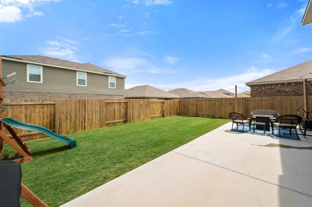 159 Sammy Fowler Avenue Venus, TX 76084 - Photo 31 of 36 a view of backyard with seating area and green space
