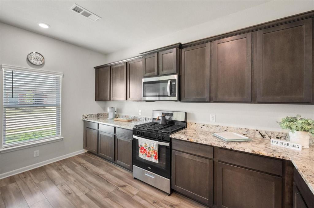 159 Sammy Fowler Avenue Venus, TX 76084 - Photo 8 of 36 a kitchen with a sink stove and cabinets
