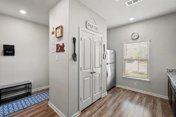 a view of a hallway with entryway door