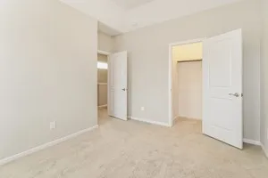an empty room with windows and closet