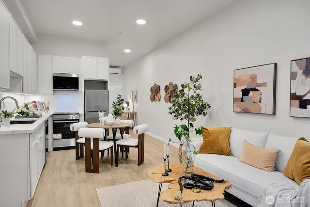a living room with furniture and a dining table with kitchen view