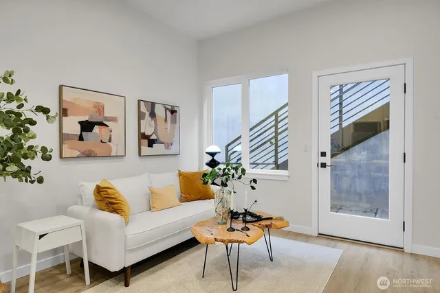 a living room with furniture and a potted plant