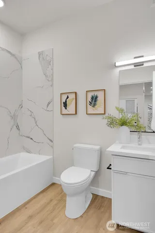 a bathroom with a toilet a sink and bathtub