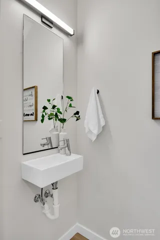 a bathroom with a sink mirror and vanity