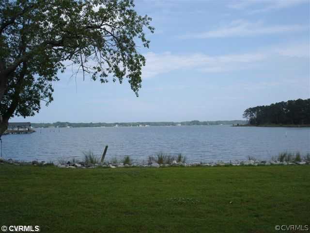385 Ballast Point Road Hudgins, VA 23076 - Photo 8 of 12 a view of a lake from a yard