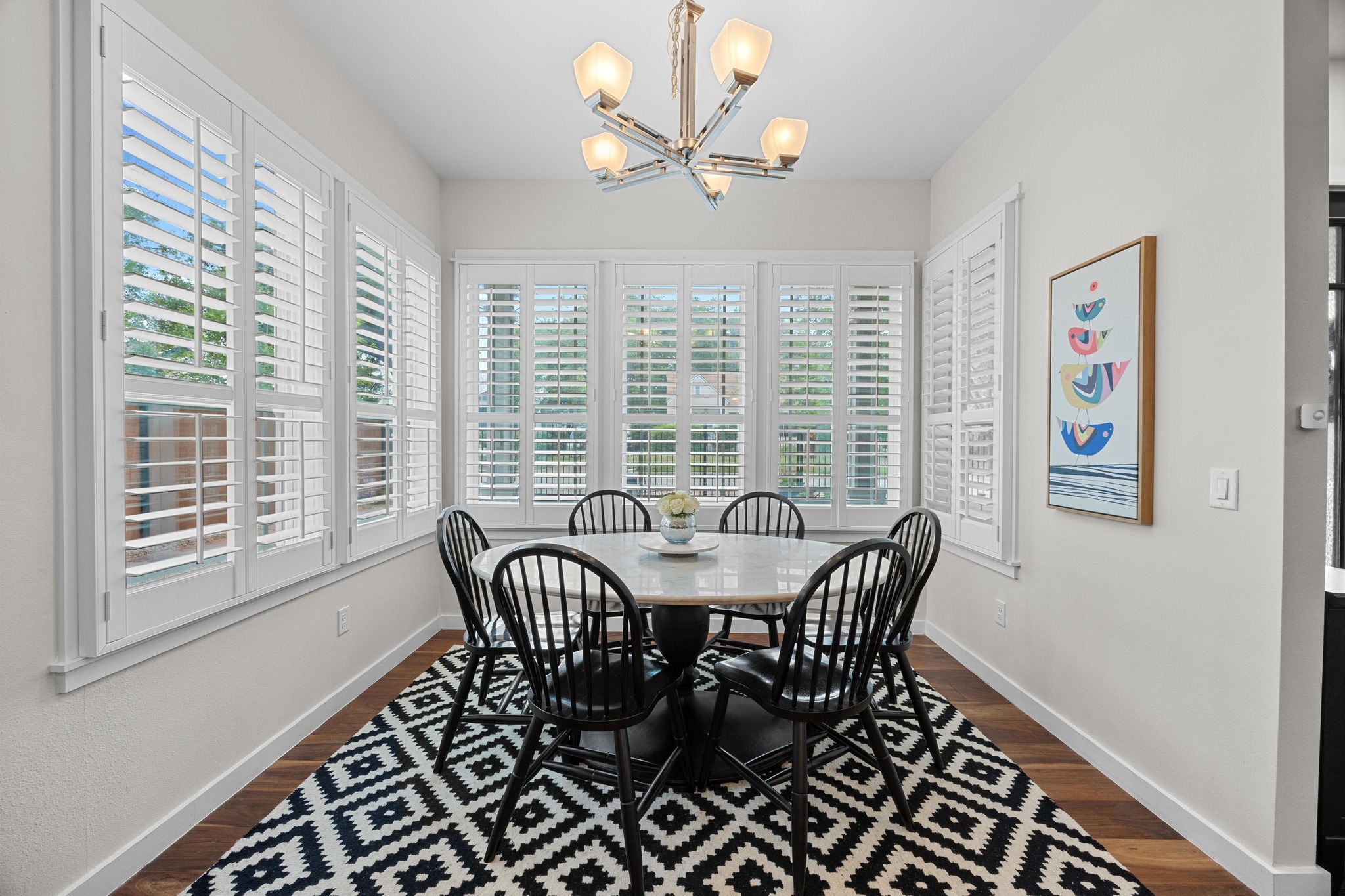 3907 Becker Avenue Austin, TX 78751 - Photo 10 of 37 Open dining area with plenty of natural light, custom shutters and dark wood flooring.