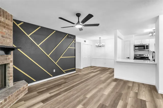 a view of empty room with wooden floor and window