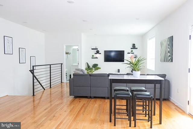 1416 22nd Street Southeast, Unit 2 Washington, DC 20020 - Photo 4 of 18 a living room with furniture a flat screen tv and a wooden floor