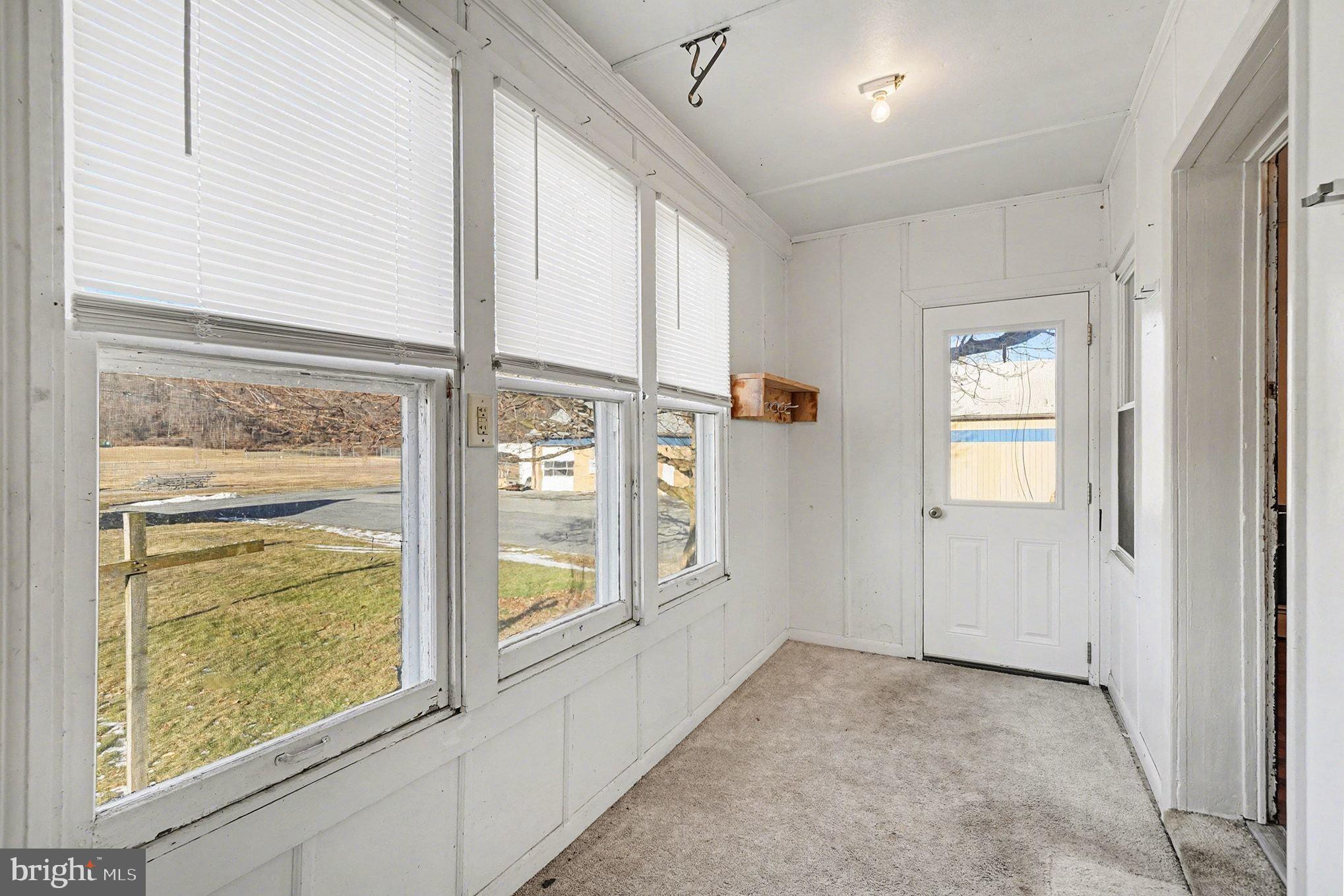325 East Market Street Beavertown, PA 17813 - Photo 10 of 41 329 rear enclosed porch/ storage mud room.