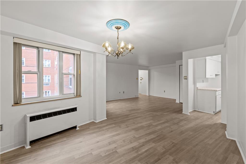 4625 Fifth Avenue, Unit 209 Pittsburgh, PA 15213 - Photo 11 of 23 wooden floor in an empty room with a window