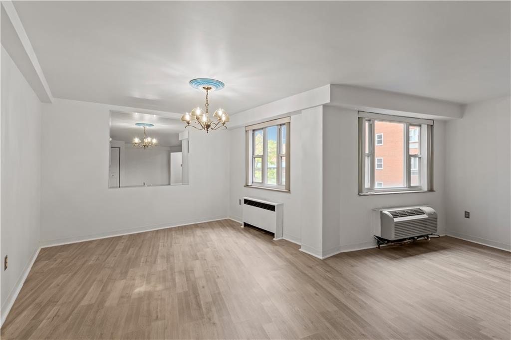 4625 Fifth Avenue, Unit 209 Pittsburgh, PA 15213 - Photo 12 of 23 a view of an empty room with window and wooden floor
